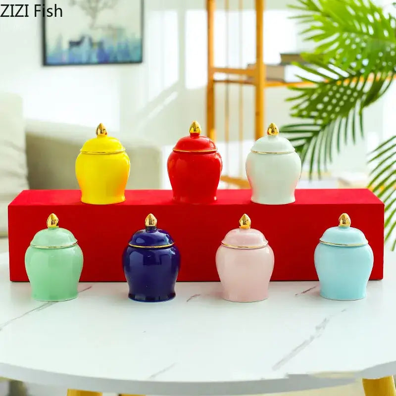 Set of six colorful ceramic storage jars with gold-trimmed lids in yellow red white green blue and pink for kitchen use