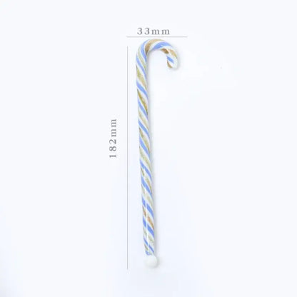 A colorful christmas long handle glass stirring stick shaped like a candy cane with light blue and gold stripes
