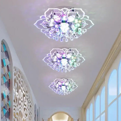 Three elegant colorful crystal flower ceiling light fixtures with multicolored lights and clear glass elements for living room