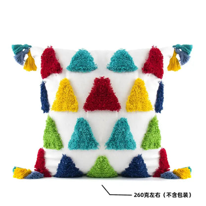 White cushion with colorful fluffy triangular pom-poms and tassels in red teal yellow green and blue decorbites geometric tassel pillowcase