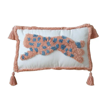 A cream-colored decorbites geometric tassel pillowcase with a hand-embroidered pink leopard and blue spots for decor