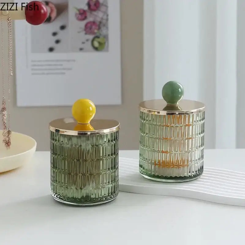 Two colorful glass tea canisters with gold ceramic lids and yellow and green knobs storage jar decorbites glass tea