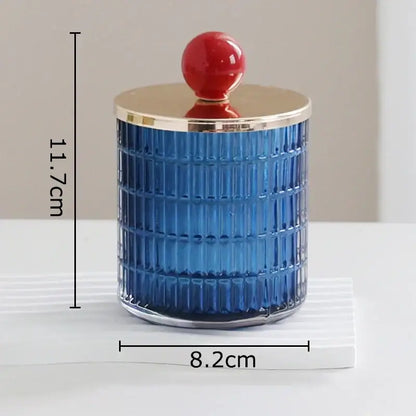 Blue glass tea canister with a gold rim and red spherical lid from decorbites glass tea storage jar set