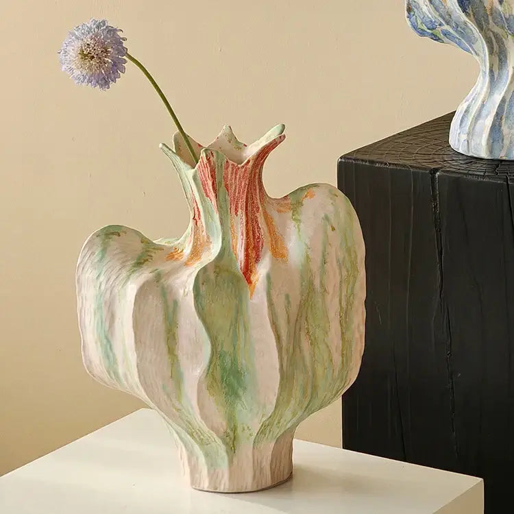 A colorful irregular ceramic petal vase with organic leaf-like contours and soft green peach cream glaze for living room decor