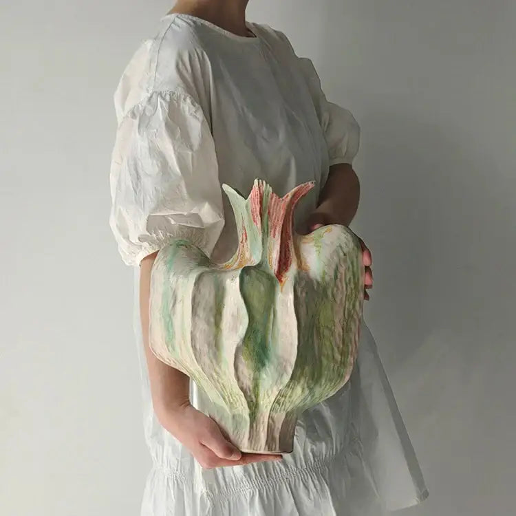 A colorful irregular ceramic petal vase with soft green and pink glazes for living room decor by decorbites