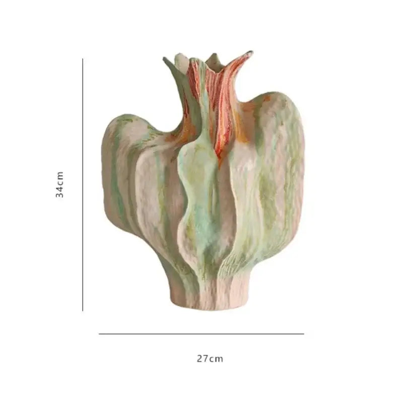 A colorful irregular ceramic petal vase in muted green beige with warm orange accents for living room decor by decorbites