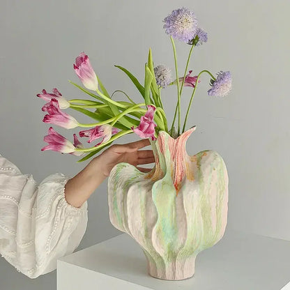 Pastel green and pink colorful irregular ceramic vase with textured organic form holding tulips and scabiosa for decorbites colorful irregular living room decor