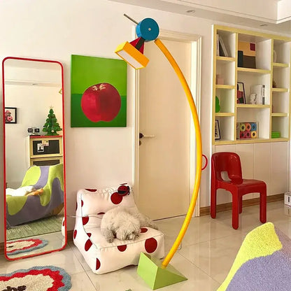 Vibrant yellow curved floor lamp with blue circular top and colorful geometric light fixture decorbites kids treetop led