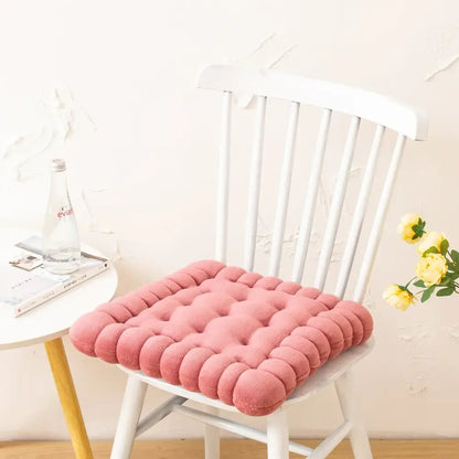 Pink tufted cookie biscuit cushion with soft plush texture and rounded button details for living room use