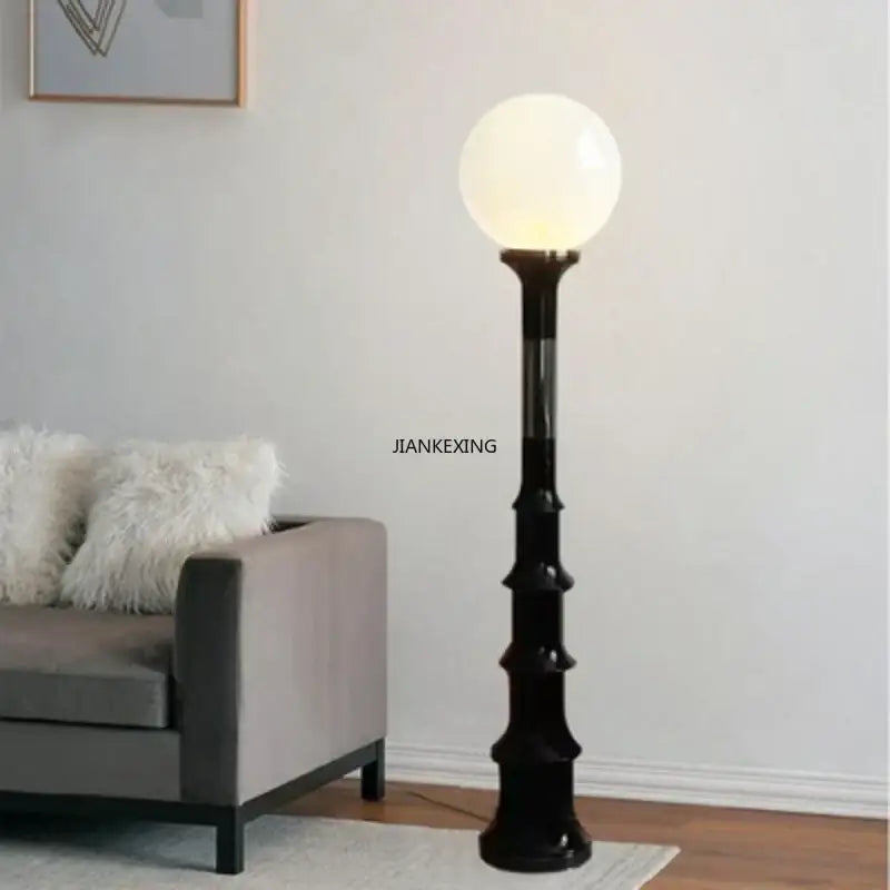 Black bamboo style floor lamp with glowing white spherical bulb from decorbites colorful retro led collection for bedroom decor