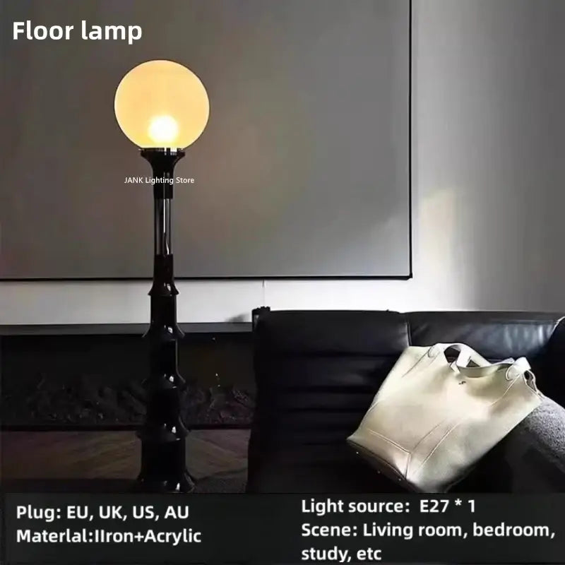 Black iron floor lamp with a spherical warm-toned acrylic globe for decorbites colorful retro led bedroom lighting