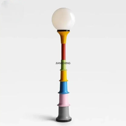 Vibrant decorbites colorful retro floor lamp with multi-colored cylindrical sections and a white glass shade for bedroom lighting