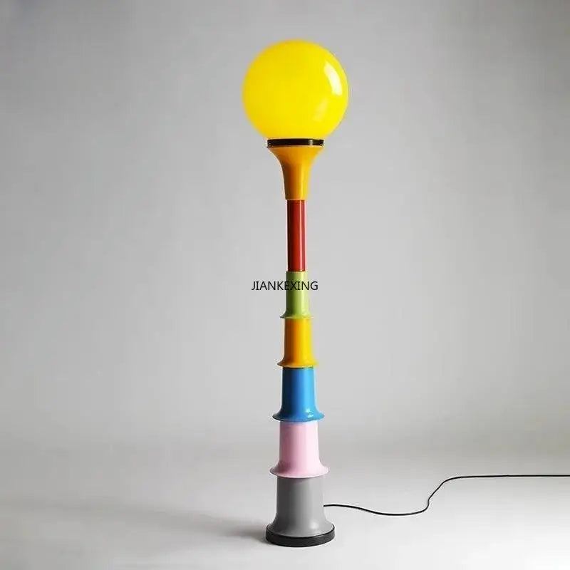 Colorful retro led floor lamp with vibrant multi-colored stacked cylinders and bright yellow spherical bulb for bedroom decorbites