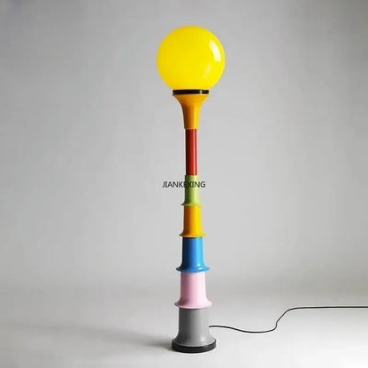 Colorful retro led floor lamp with vibrant multi-colored stacked cylinders and bright yellow spherical bulb for bedroom decorbites