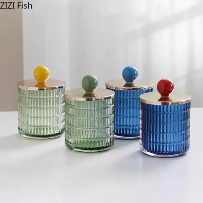 Set of four colorful decorbites glass tea canisters with ribbed glass bodies and metallic lids as storage jars