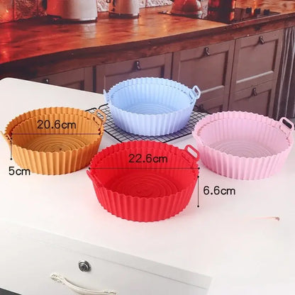 Set of four colorful silicone basket trays in orange blue red and pink with fluted edges for baking grill pan use