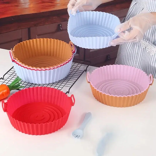 Set of colorful silicone basket trays in red pink light blue and orange with fluted edges for baking grill pan use