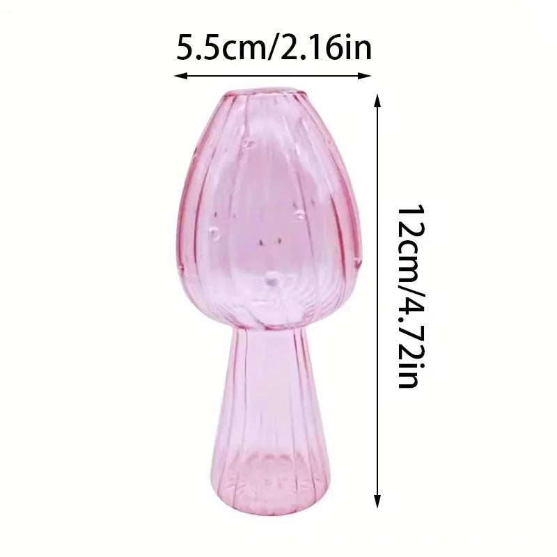 A translucent pink glass mushroom vase with ribbed texture for hydroponic aromatherapy and desktop decoration