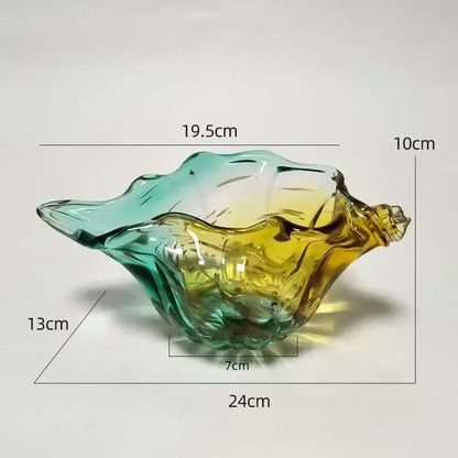 A decorbites conch candy jar made of translucent glass with green to amber gradient shaped like a seashell tray