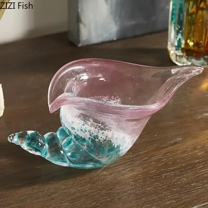 Translucent glass shell-shaped conch candy jar with pink rim and turquoise base featuring swirling patterns by decorbites conch