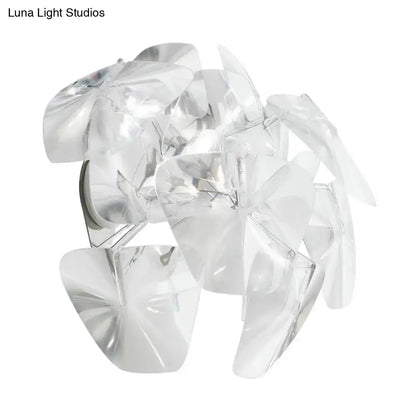Clear faceted acrylic petals form a transparent glass shade on a contemporary acrylic single sconce light fixture