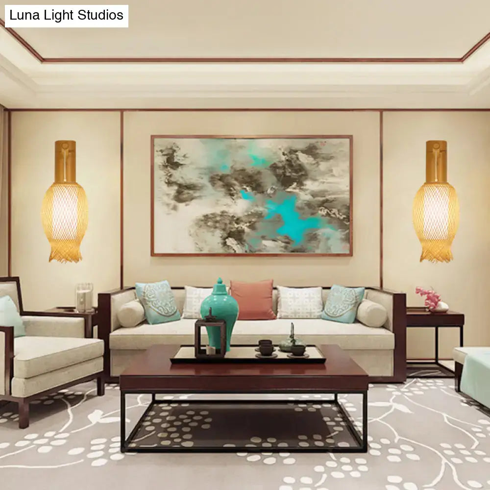 Teal ceramic vase with bulbous body on dark wooden tray beside contemporary bamboo golden wall light fixture for bedroom