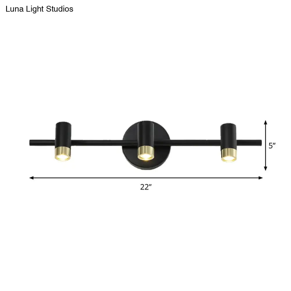 Contemporary black and brass three-light wall sconce vanity light with adjustable color temperature for bathroom use