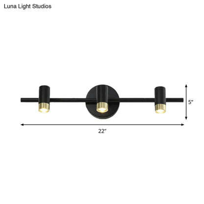 Contemporary black and brass three-light wall sconce vanity light with adjustable color temperature for bathroom use