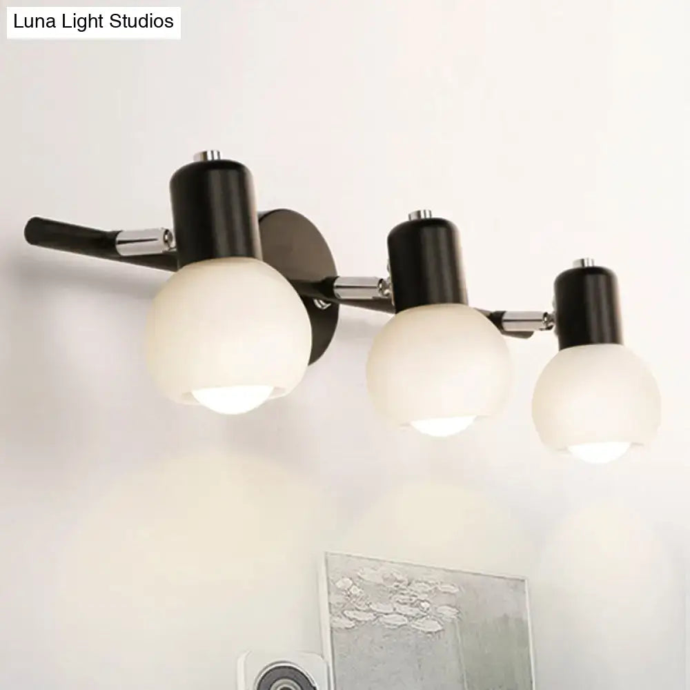Contemporary black and chrome wall-mounted living room light fixture with three frosted milk glass globe shades