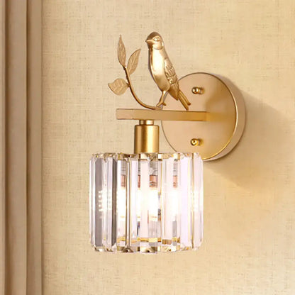 Contemporary black and gold wall lamp with bird detail and cylindrical crystal shade compatible with e12 e14 light type