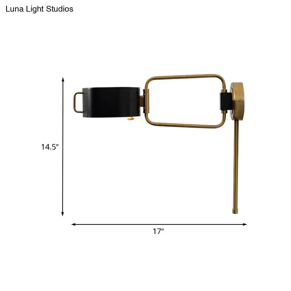 Contemporary black and gold drum wall sconce with brass adjustable arm and rectangular shade for bedroom wall light