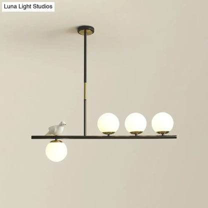 Decorbites contemporary linear branch dining pendant light with black brass finish cream glass bulbs and ceramic bird
