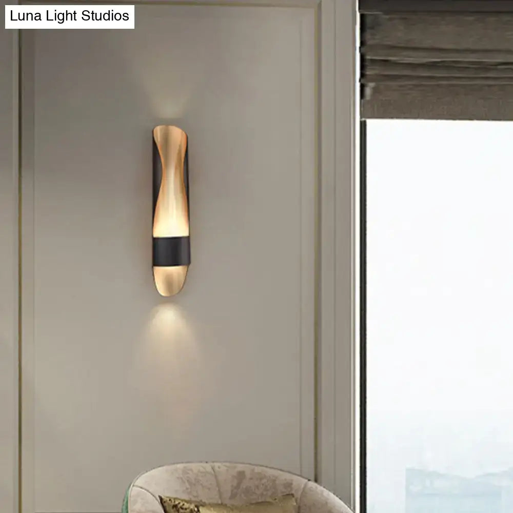 Contemporary black and gold twisted led wall sconce with sleek curved gold tones and contrasting black horizontal band for bedroom lighting