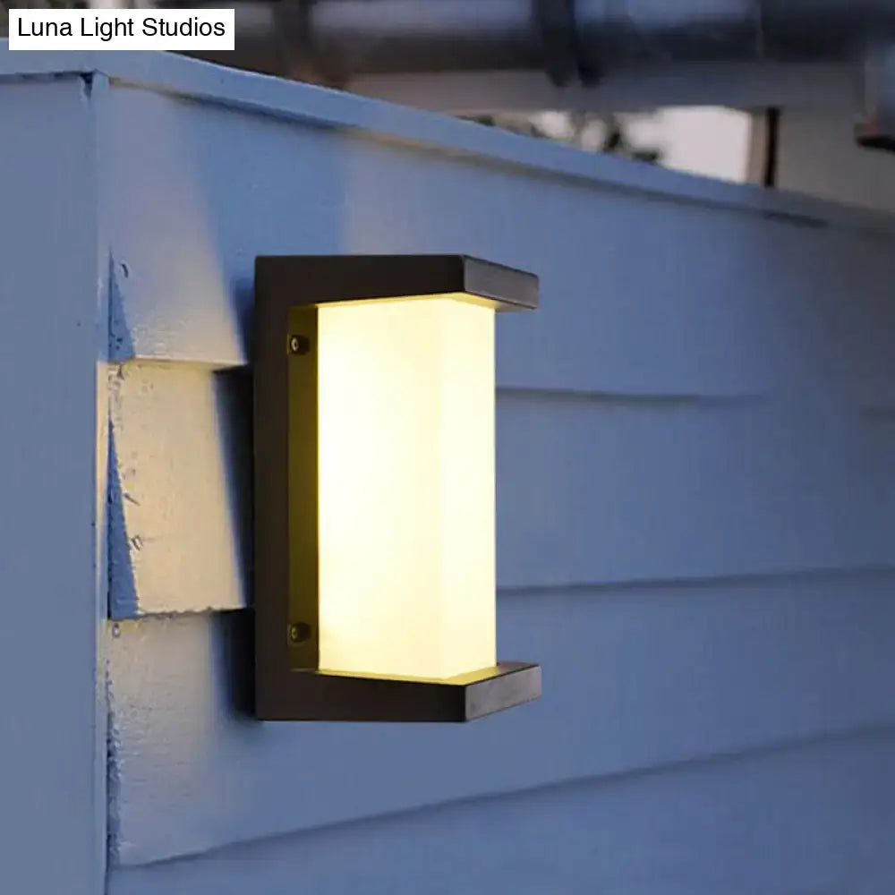 Contemporary black led wall lamp with frosted glass panel providing warm diffused glow for outdoor use