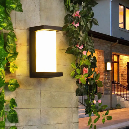 Contemporary black rectangular led wall lamp with warm glowing panel mounted flush for outdoor courtyard use