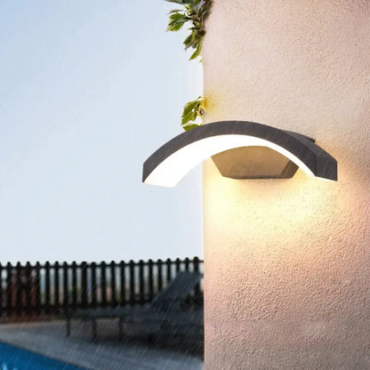 Contemporary black led wall lamp featuring a modern curved design emitting warm white light for courtyard use