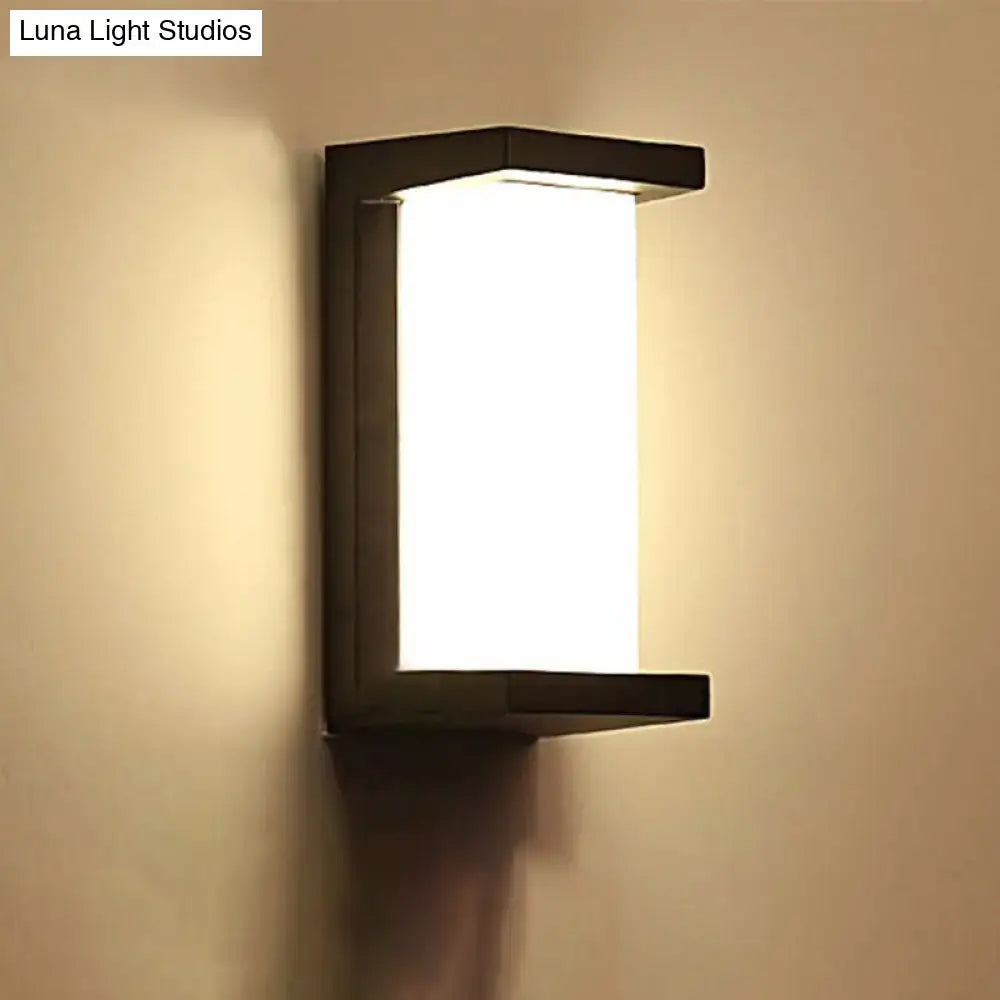 Contemporary black led wall lamp with rectangular frosted glass panel emitting warm diffused light flush mount sconce