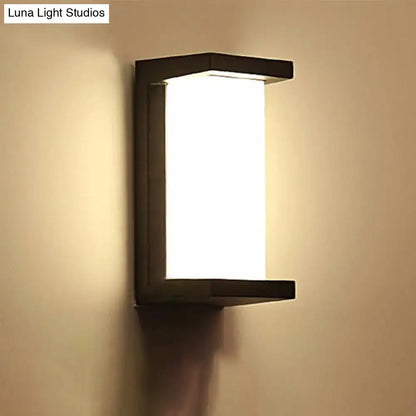 Contemporary black led wall lamp with rectangular frosted glass panel emitting warm diffused light flush mount sconce