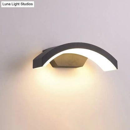 Modern black led wall lamp with curved minimalist design providing warm ambient lighting for contemporary spaces