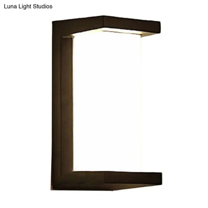 Contemporary black led wall lamp with a modern black-framed rectangular illuminated glass panel for outdoor use