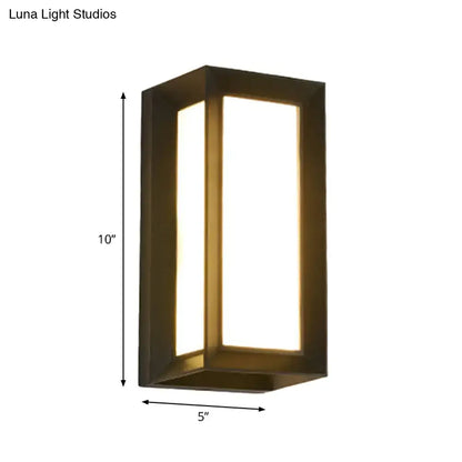 A sleek rectangular dark bronze wall lamp with warm LED lighting for contemporary outdoor courtyard settings