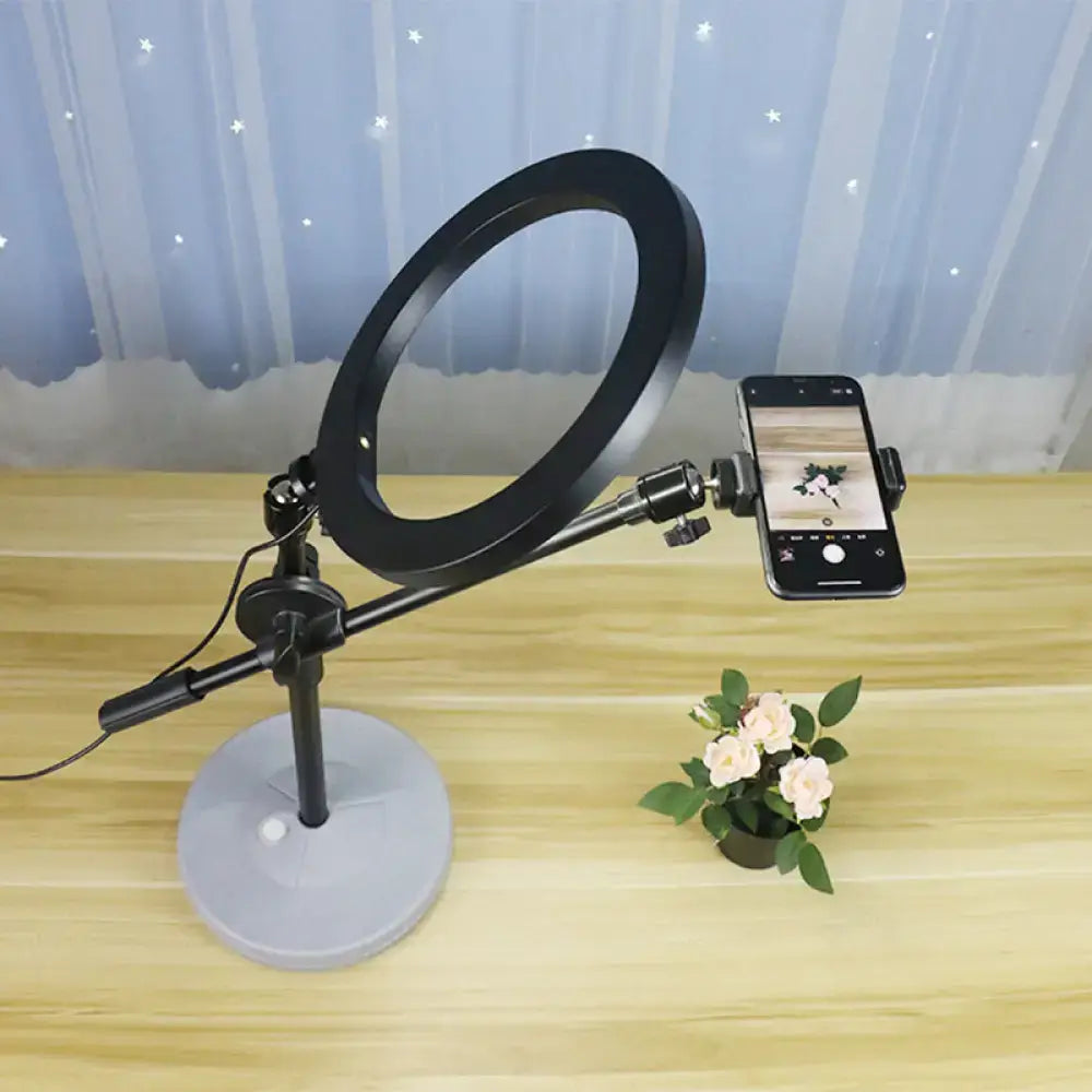 Contemporary black round shaped metal vanity light with adjustable arm and phone mount on a gray base 220v-240v 110v-120v