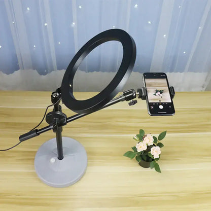 Contemporary black round shaped metal vanity light with adjustable arm and phone mount on a gray base 220v-240v 110v-120v
