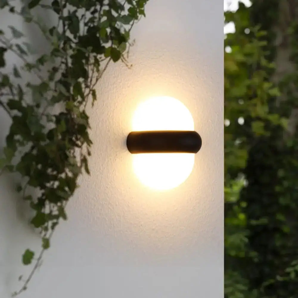 Contemporary black semi-sphere wall sconce with warm-toned circular light for outdoor area and wall lamp use