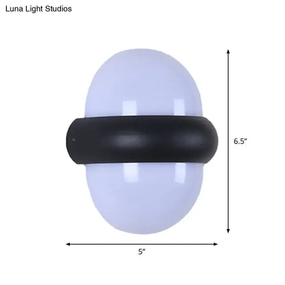 Contemporary black wall sconce with frosted white oval glass and matte band, ideal for outdoor area wall lamp use