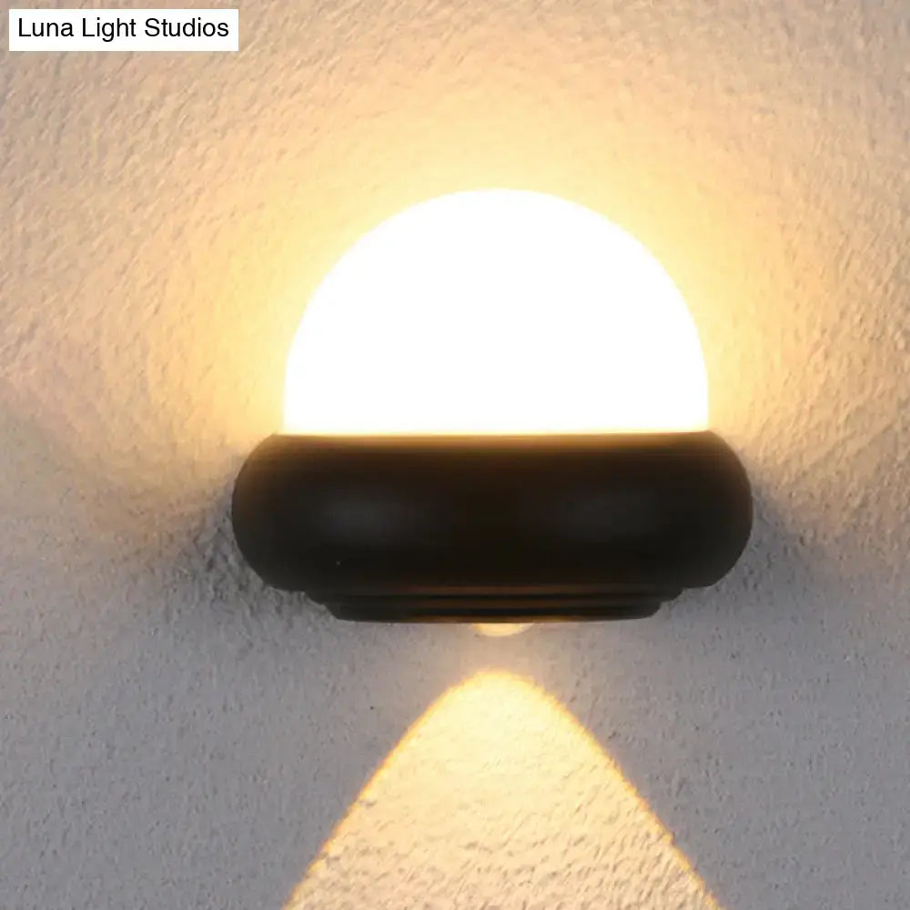 Contemporary black semi-sphere wall sconce with matte black base and frosted glass diffuser for outdoor area lighting