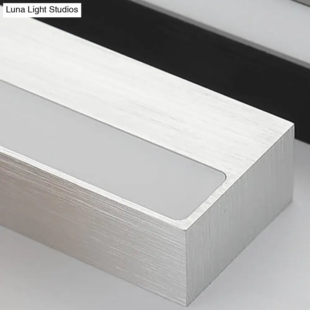 Contemporary black and silver linear vanity sconce with silver brushed aluminum and frosted glass panel for white warm light