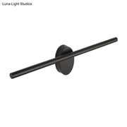 Contemporary black matte wall light with slim cylindrical bar and circular base designed for natural light in bedrooms