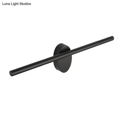 Contemporary black matte wall light with slim cylindrical bar and circular base designed for natural light in bedrooms