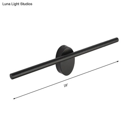 Contemporary black matte wall light with slim cylindrical bar and circular base for natural light in bedroom